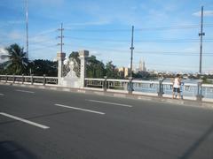 Mabini Bridge over Pasig River in Manila with cityscape and river reflections