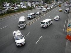 North Avenue and EDSA interchange near SM City North EDSA in Quezon City with heavy traffic and tall buildings