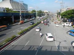 North Avenue in Quezon City approaching EDSA interchange with visible traffic and urban buildings