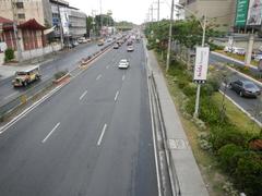 North Avenue and EDSA interchange near SM West in Quezon City with heavy traffic and high-rise buildings