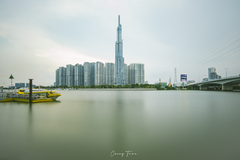 Landmark 81 skyscraper and Saigon Waterbus on Saigon River at sunset