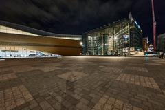 Helsinki Central Library Oodi illuminated at night with modern glass architecture