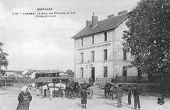 Historic photo of the Gare de Vannes Morbihan local railway station around 1910 with vintage cars waiting