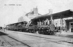 Interior view of Vannes train station around 1900 with a steam train and two steam locomotives