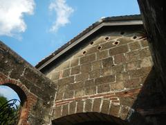 Baluarte de San Diego historic stone fort and gardens with coral trees and curved corners in Intramuros Manila