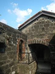 Baluarte de San Diego Gardens with old stone fort and coral trees in Intramuros Manila Philippines