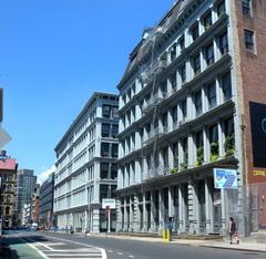 Cast iron factory buildings along Grand Street and Broadway in Soho, New York City on a sunny midday