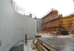 Roberto Galasso at DARC construction site with heavy machinery and scaffolding