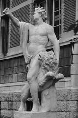 Statue of a man with a lion in a garden during summer 1990