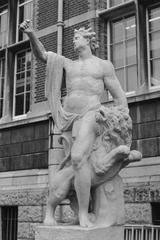 Sculpture of a man with a lion in a garden during summer 1990