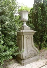 Sculpture of a vase on a pedestal in a garden, photographed in June 2003