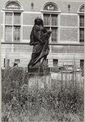 Sculpture of a female figure with scissors and a spindle representing Fate, located in the garden in front of the south facade of the villa at the 17th-century Zwaansvliet estate in Beemster, with south facade featuring relief with the name J. Hackaert and portrait of J.W. Both in the background
