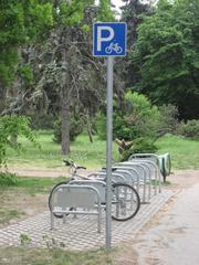 Bicycle parking lots on Margaret Island in Budapest Hungary with a view of the Danube River