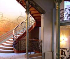 Stairway of Tassel House Brussels with ornate ironwork and wooden handrail