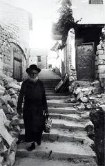 Safed Simta narrow alley with white-washed stone buildings and arches