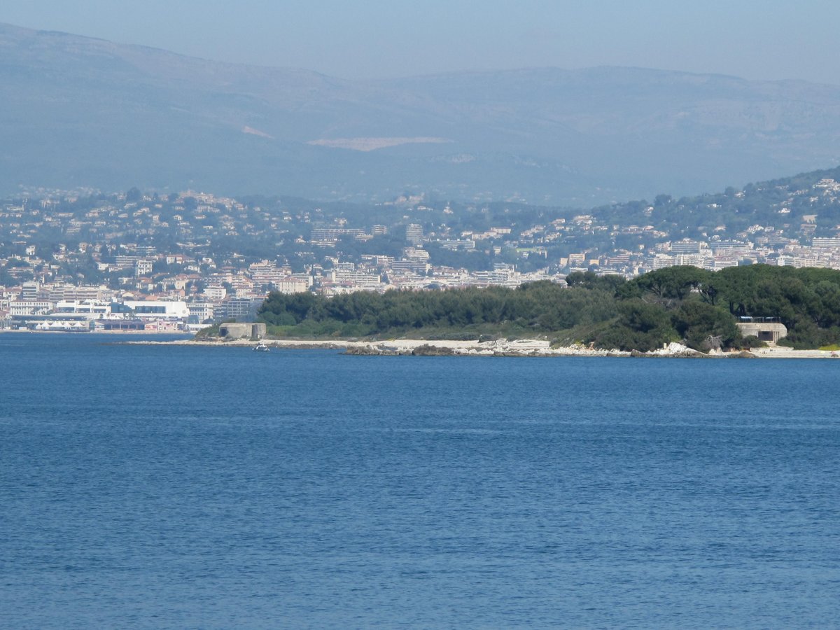 Blockhauss of Bateguier cape and Dragoon cape on Sainte-Marguerite island with Palais des Festivals in Cannes in background