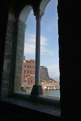 View of the Church of Santa Margherita d'Antiochia in Vernazza overlooking the small harbor and rocky coastline