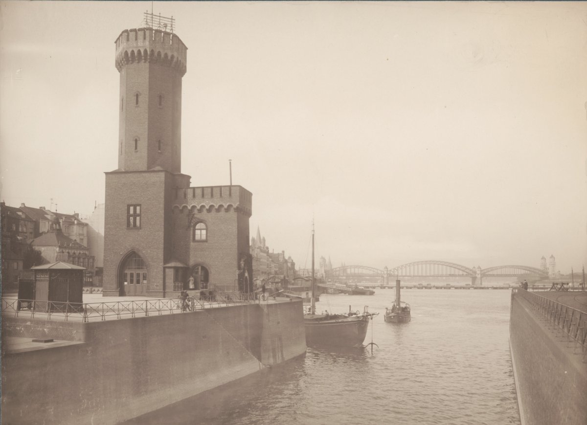 Historical view of Köln harbor entrance with Schiffbrücke and Hohenzollernbrücke bridges in 1912