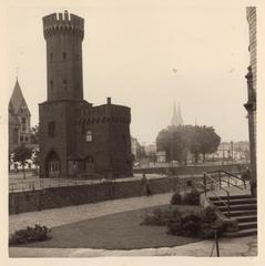 Historic black and white photograph of Malakoffturm tower between 1930 and 1950 with person likely Joop van Beem standing nearby