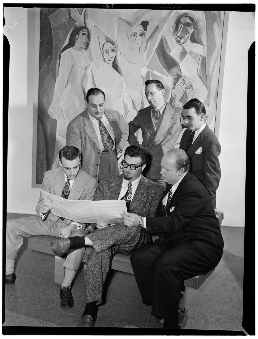 Black and white portrait of jazz arrangers Ralph Burns, Edwin A. Finckel, George Handy, Neal Hefti, Johnny Richards, and Eddie Sauter at the Museum of Modern Art in New York, 1947