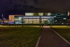 Helsinki Music Centre illuminated at night with its modern glass architecture