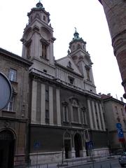 Sacred Heart Basilica in Zagreb, large church with twin towers and clock faces under a clear blue sky