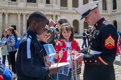 U.S. Marine Corps trumpet player signing pamphlet at Les Invalides in Paris