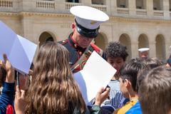 U.S. Marine Corps Drum Major Bryan Williams signing pamphlets after performance at Les Invalides Paris 2022