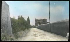 View down the ancient Appian Way road towards the Tomb of Caecilia Metella in Rome