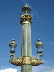 View of Place de la Concorde in Paris with historical buildings and cloudy sky