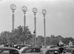 Poles with symbols near the French pavilion with car traffic at the 1937 Paris World Exhibition