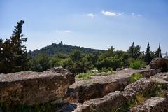View of Philopappos Hill from the Stoa of Eumenes on a clear day