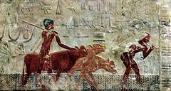 Ancient Egyptian wall painting depicting seated figures and hieroglyphs