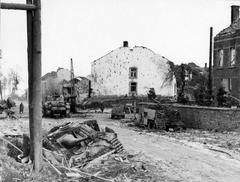 Destroyed German Sturmgeschütz III, U.S. M4 Sherman tank and U.S. M3 half-track vehicles in Houffalize Belgium January 1945