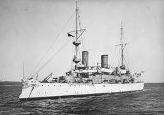 Port bow view of the USS Olympia cruiser at sea in 1902