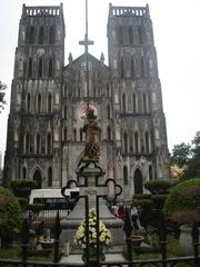 St. Joseph's Cathedral in Hanoi at sunset with lit facade and clear blue sky
