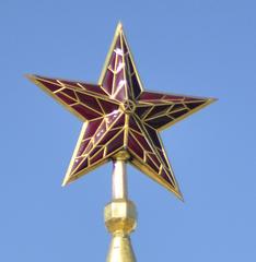 Red Kremlin star glowing on top of a tower at night