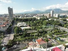 Panoramic view of Tirana cityscape with urban buildings and mountainous background