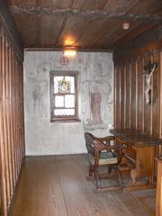 Late Gothic cell from the former St. Agnes women's monastery in Schaffhausen with ceiling carving of Arma Christi forming the word 'Jesus'