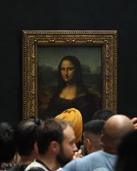 The Mona Lisa painting by Leonardo da Vinci displayed in the Louvre Museum