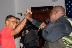 Michael Trotter Jr. of The War and Treaty high-fiving a concert attendee at Aviano Air Base
