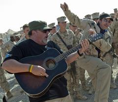 Songwriter Bob DiPiero and country music artist Kix Brooks of Brooks & Dunn performing for U.S. Marines at Camp Hanson, Afghanistan
