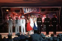 Brooke Shields and fellow entertainer singing to US Navy and Marine Corps personnel during USO concert at International Naval Review in New York Harbor