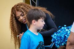 Sam Franklin Jr. from the Carolina Panthers, TopCat Cheerleaders, and Sir Purr mascot at the 2d Cavalry Regiment Dragoon Inn Warrior Restaurant community outreach event
