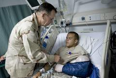 Navy Admiral Mike Mullen awards Purple Heart medal to Army Sergeant Marcus Love at Bagram Air Field, Afghanistan, 2009