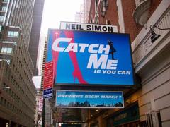 Front exterior view of a theater marquee displaying Catch Me If You Can