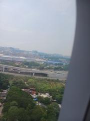 Aerial daytime view over the western tip of Libingan ng mga Bayani cemetery near Manila airport runway 24