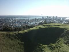 View of Mount Eden crater and Auckland CBD skyline in Auckland City, New Zealand