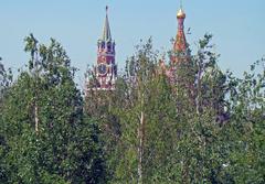 View of Spasskaya Tower and Saint Basil's Cathedral through trees in Zaryadye Park, Moscow