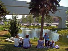 People resting near the artificial pond in Zaryadye Park Moscow